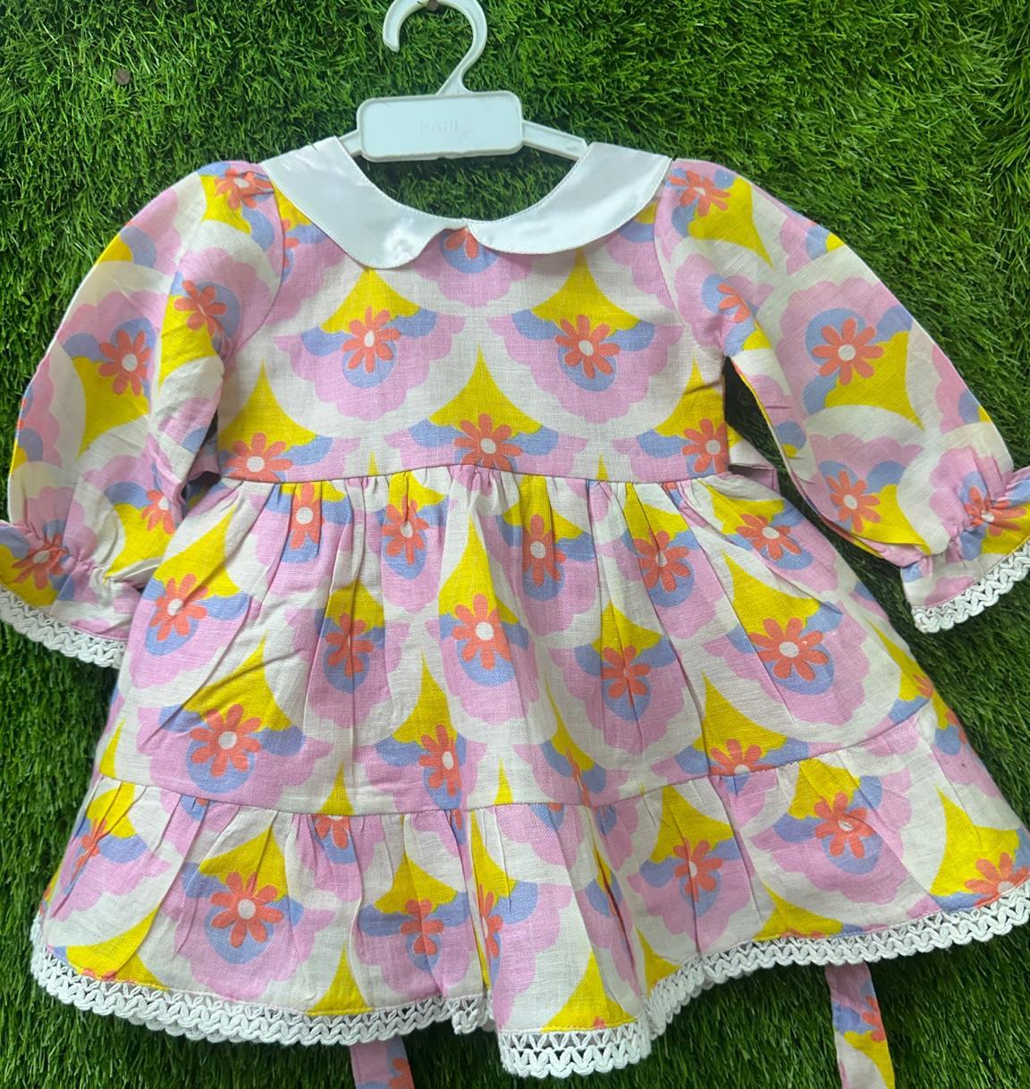 Pink floral print dress on hanger