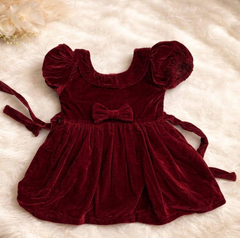 Deep burgundy velvet puff-sleeve baby dress with bow detail