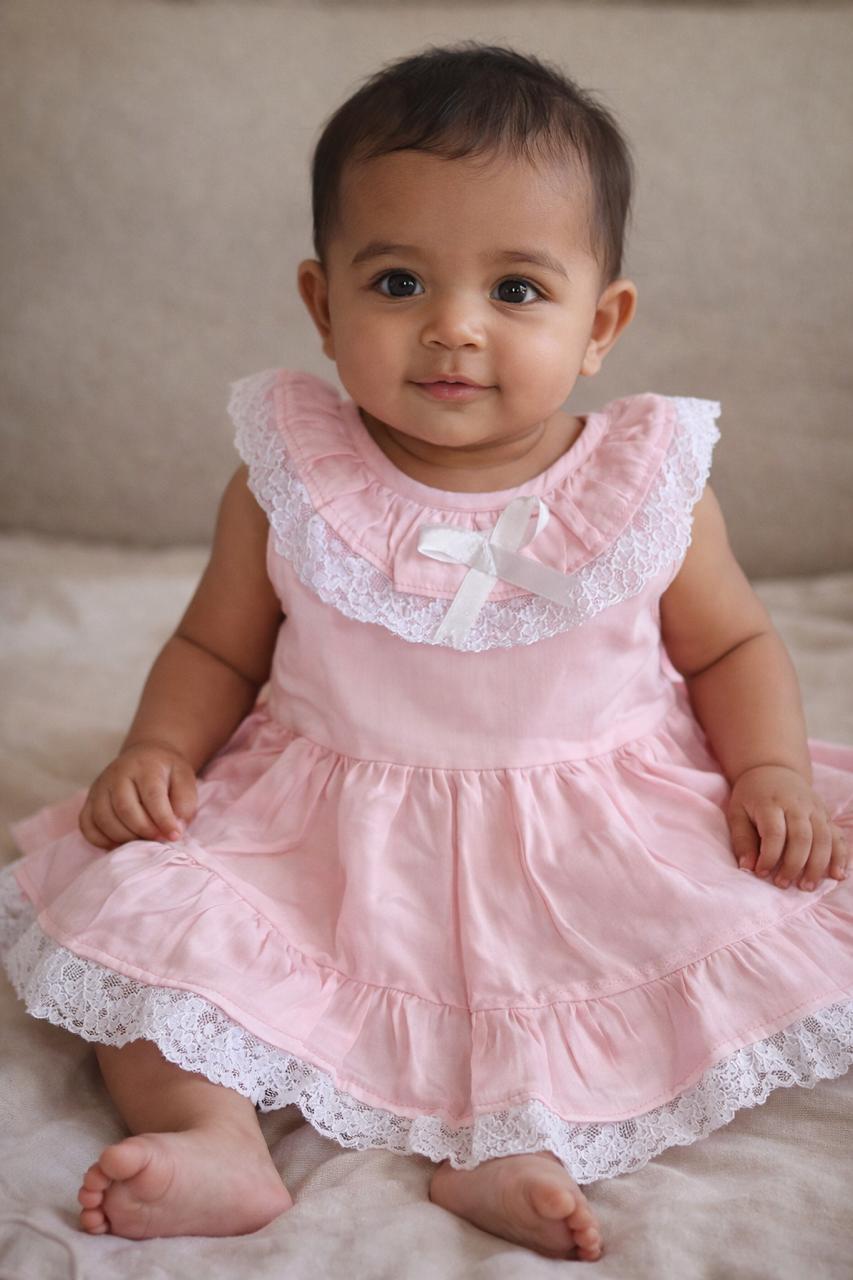Pink lace ruffle dress displayed on basket
